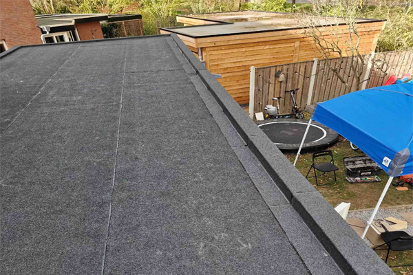 a modern, durable flat roof likely made of EPDM rubber membrane or a felt system